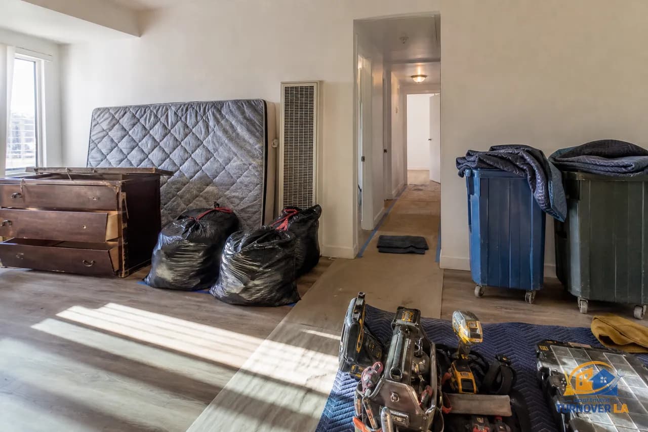 Koreatown LA apartment cleanout during a junk removal job, with mattress and furniture staged for haul out and protective floor runners in place
