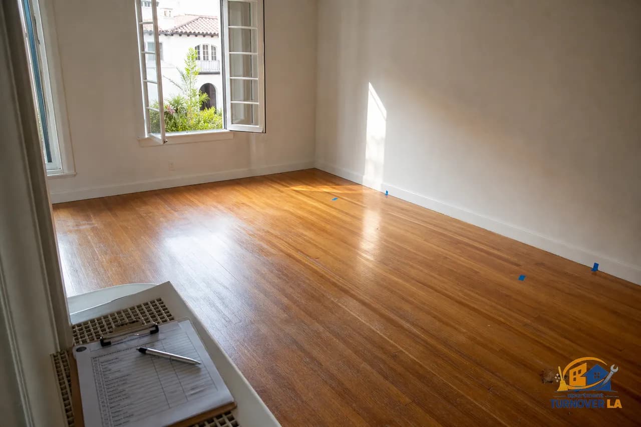 Los Angeles apartment hardwood floor marked for repair during move-out inspection with checklist, flooring damage assessment