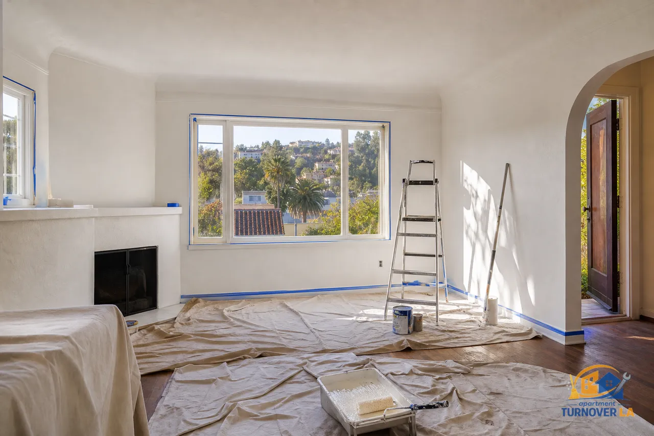 Los Angeles 1,200 sq ft bungalow living room mid-interior paint with rollers, taped trim, and sunlight in a Silver Lake setting