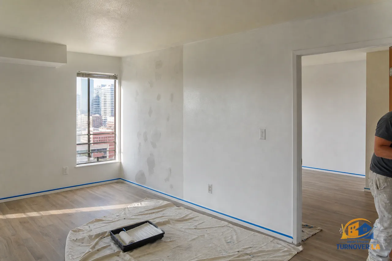 LA apartment turnover painting in a Koreatown one-bedroom with taped trim, roller and drop cloths during a move-out repaint