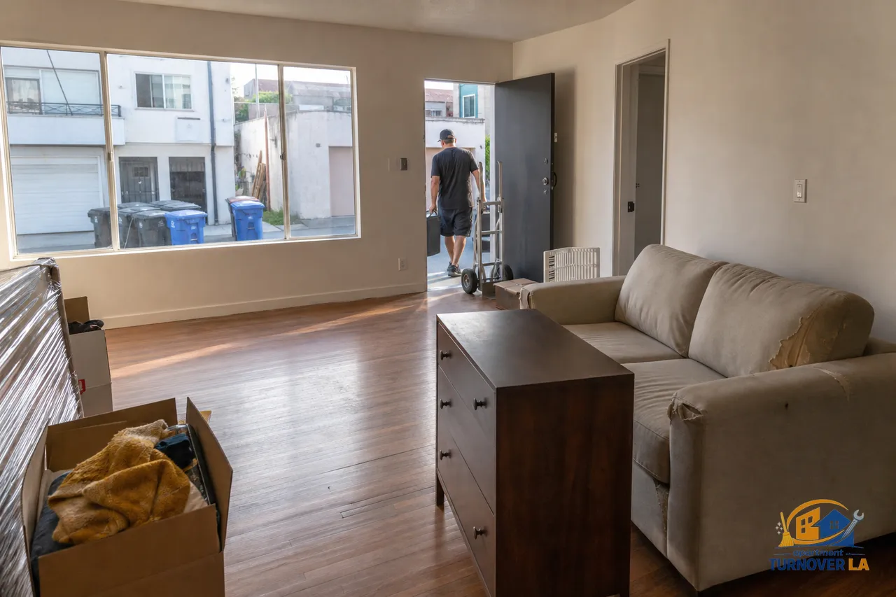 LA apartment living room with a sofa and dresser staged by the door for bulky item pickup in Koreatown, showing a practical furniture removal scene